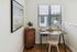 Charming home office nook with sleek wooden desk, cozy chair, and bright desk lamp, perfect for productivity and creativity.