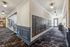 Elegant apartment hallway with modern mailboxes, luxurious carpeting, and bright lighting.