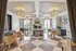 Elegant communal area featuring luxurious chandeliers, modern decor, and stylish furniture with abundant natural light.