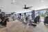 Modern fitness center with state-of-the-art equipment, bright natural lighting, and sleek design.
