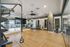 Luxurious home gym featuring modern equipment, mirrored walls, and polished wooden floors for a premium workout experience.