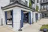 Chic outdoor patio with private cabanas, featuring white brick and elegant blue curtains at a modern apartment complex.