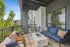 Charming balcony with modern seating, plush cushions, and greenery for a relaxing outdoor retreat.