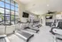 Bright and modern apartment gym with state-of-the-art treadmills, large windows, and sleek decor for an energizing workout.