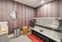 Cozy apartment tanning room featuring a sunbed, vibrant striped wallpaper, and modern decor for a relaxing experience.