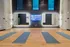 Modern fitness studio with sleek design, vibrant lighting, and neatly arranged yoga mats for an inviting workout atmosphere.