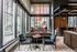 Modern apartment lobby with high ceilings, large windows, and elegant seating area featuring stylish furniture and a contemporary chandelier.