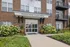 Welcoming entrance of Harper House Leasing Office with beautiful landscaping and charming balconies.