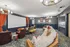 Elegant home theater room with plush seating, large projection screen, vibrant decor, and modern lighting.