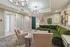 Chic and inviting living room with a plush green sectional sofa, elegant lighting fixtures, and stylish wall art, perfect for relaxation and entertaining.