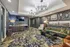 Luxurious lounge area in modern apartment with stylish lighting, elegant wall art, and plush seating.