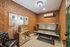 Cozy tanning bed room with stylish patterned wallpaper, elegant lighting, and chic decor accents.