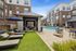 Luxurious outdoor area with comfortable cabanas, inviting pool, and stylish lounge chairs in a modern apartment complex.