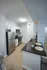 Modern kitchen with sleek stainless steel appliances, elegant dark granite countertop, and cozy breakfast bar seating.
