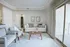 Bright and inviting living room featuring elegant decor, cozy seating, large window with sliding door, and modern touches.