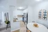 Modern apartment kitchen with sleek granite countertops, stainless steel appliances, and a cozy dining area featuring stylish decor.