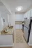 Contemporary kitchen with sleek stainless steel appliances, elegant granite countertops, and stylish white cabinetry for a modern look.