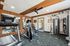 Modern and well-equipped fitness center featuring state-of-the-art cardio machines, weight equipment, and large mirrors.