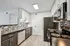 Modern kitchen with sleek stainless steel appliances, contemporary tile backsplash, and elegant wood flooring.