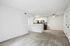 Bright and inviting open-plan living area with a modern kitchen featuring sleek cabinetry and stainless steel appliances.