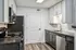 Contemporary kitchen with sleek dark countertops, stainless steel appliances, and elegant cabinetry for a modern touch.