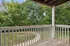Charming balcony view overlooking a lush, verdant garden with a winding pathway, offering serene and picturesque outdoor relaxation.