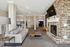 Inviting communal lounge with cozy seating, elegant stone fireplace, and modern decor for ultimate relaxation.