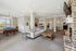 Inviting communal lounge featuring a stylish seating area, stone fireplace, pool table, and abundant natural light.