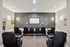 Luxurious home theater room with plush cinema seating, wall-mounted screen, and ambient lighting for an immersive entertainment experience.