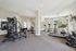 Bright and modern fitness center with state-of-the-art gym equipment, large windows, and ample space for workouts.