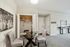 Inviting dining area in a modern apartment with elegant chairs, round glass table, and stylish decor.