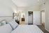 Elegant bedroom with plush bedding, en-suite bathroom, and a spacious closet, exuding comfort and style.