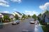 Charming suburban street scene with modern homes, lush greenery, and a clear blue sky, showcasing a vibrant and welcoming neighborhood.