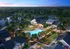 Elegant aerial view of a luxurious residential community featuring a stunning pool area surrounded by lush landscaping, modern architecture, and serene pond with a fountain at sunset.