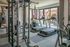 Bright and modern fitness center featuring treadmills, stationary bikes, and strength training equipment with large windows for natural light.