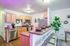 Charming modern kitchen with light wood cabinetry, sleek stainless steel appliances, and a cozy breakfast bar adorned with stylish dinnerware, perfect for casual dining and entertaining.