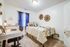 Cozy bedroom with stylish decor, featuring a single bed, chic desk setup, and warm neutral tones for a serene atmosphere.