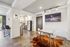 Modern apartment interior featuring a sleek kitchen with stainless steel appliances, cozy dining area, and stylish decor.