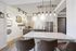 Chic modern kitchen with industrial lighting, stylish decor, and sleek appliances, ideal for contemporary living.