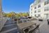 Chic outdoor patio featuring modern seating, stylish fire pits, and a grill area, perfect for social gatherings in a serene setting.