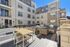 Inviting apartment terrace with stylish outdoor furniture, cozy seating area, and sunny ambiance perfect for relaxation and social gatherings.
