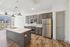 Modern kitchen with stainless steel appliances, sleek gray cabinetry, and a stylish island under elegant pendant lighting.