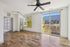 Bright and airy modern living space with hardwood floors, large sliding glass doors, and stunning urban views.
