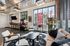 Stylish urban living area with chic modern furniture, large windows providing ample natural light, and contemporary decor creating a welcoming atmosphere.