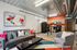 Chic apartment living area with modern furniture, vibrant artwork, and a sleek open kitchen.