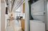 Modern apartment interior with industrial chic design, featuring an open living area, stylish dining space, and convenient in-unit laundry.