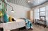 Chic bedroom with modern metal ceiling, colorful pillows, a cozy bed, artistic wall design, and ample natural light through large windows.