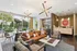 Chic lobby lounge with modern lighting, stylish furniture, and floor-to-ceiling windows overlooking a lush outdoor space.