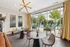 Chic interior with stylish lighting, modern seating, and vibrant poolside view, perfect for relaxation and entertaining.