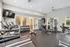Bright and contemporary fitness center featuring state-of-the-art treadmills, weight rack, and versatile exercise machines.